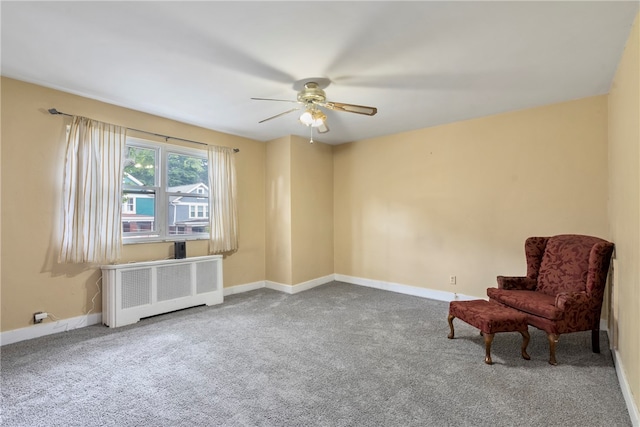 sitting room featuring radiator, carpet flooring, and ceiling fan