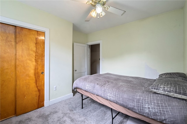 carpeted bedroom featuring a closet and ceiling fan