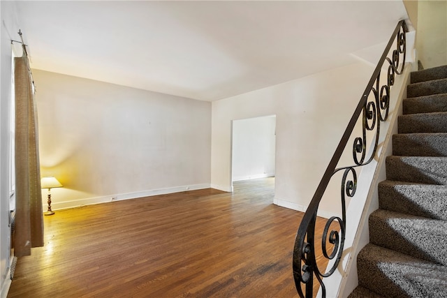 staircase with hardwood / wood-style floors