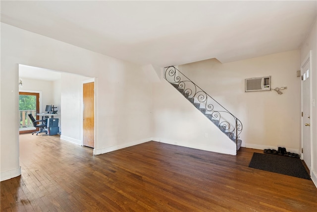 foyer featuring dark wood-type flooring and a wall mounted air conditioner