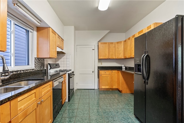 kitchen featuring black appliances, tasteful backsplash, dark tile patterned floors, sink, and dark stone countertops