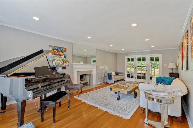 living room featuring ornamental molding, french doors, and light wood-type flooring