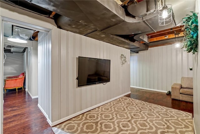 finished basement with dark wood-type flooring and baseboards