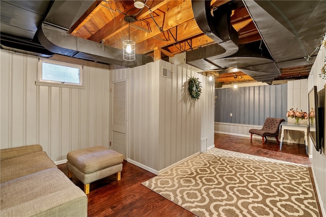 basement with dark hardwood / wood-style floors