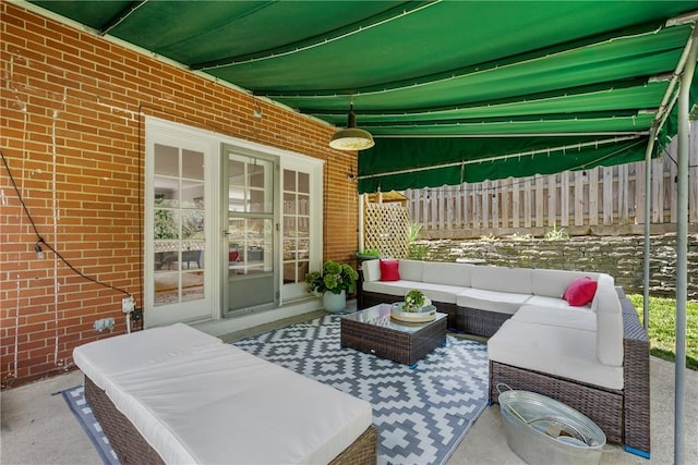 view of patio featuring an outdoor hangout area and fence