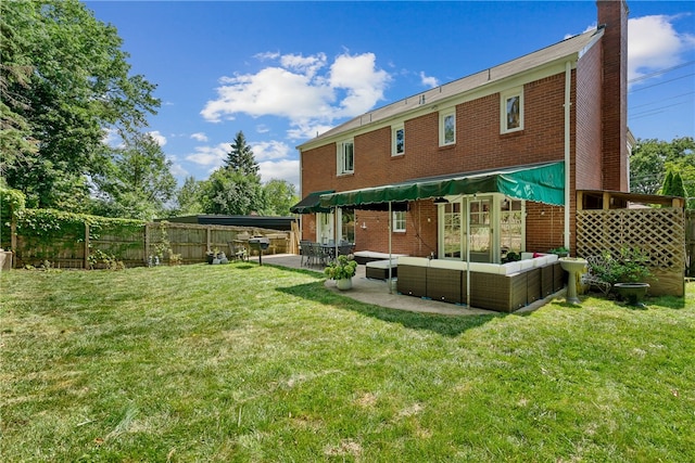 back of house featuring an outdoor living space and a yard