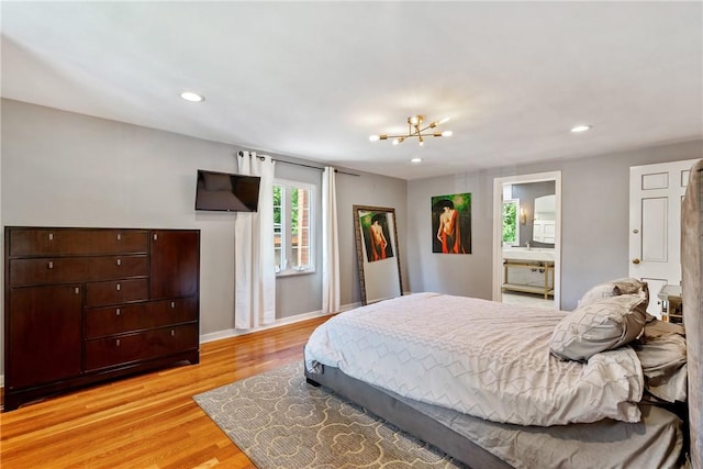 bedroom featuring light wood-type flooring, a notable chandelier, baseboards, and recessed lighting