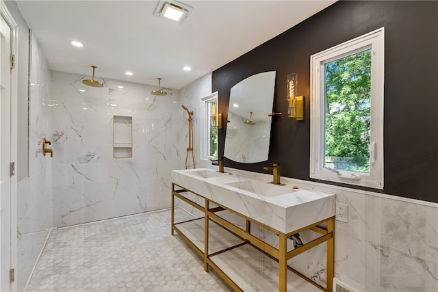 bathroom featuring tile walls, tile patterned floors, a wealth of natural light, and double sink