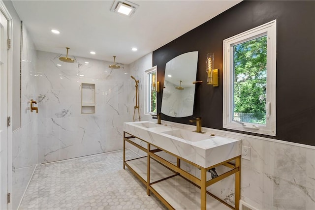 full bathroom with recessed lighting, double sink, tile walls, and a marble finish shower