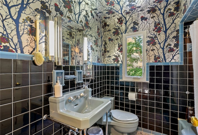 bathroom with tile patterned floors, sink, tile walls, and toilet