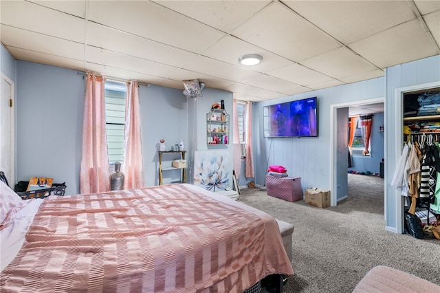 bedroom featuring a closet, carpet flooring, and a paneled ceiling