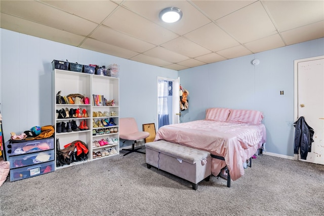 bedroom featuring carpet and a paneled ceiling