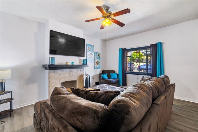 living room with a fireplace, hardwood / wood-style flooring, and ceiling fan