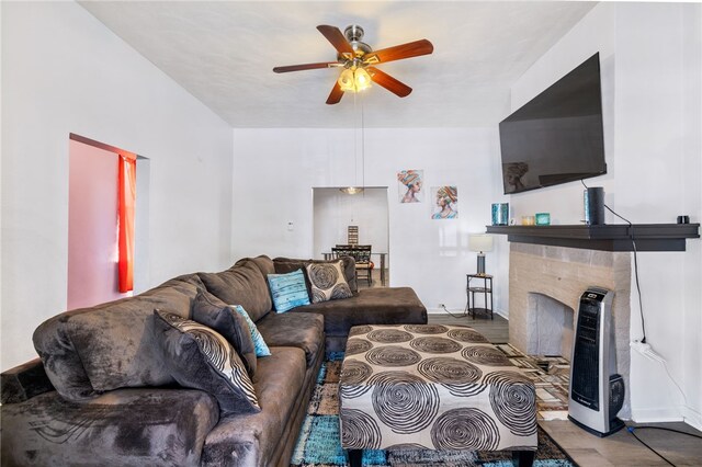 living room with a fireplace and ceiling fan