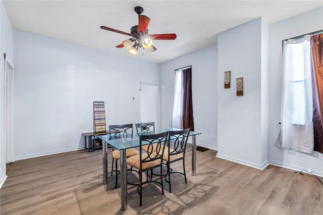 dining space featuring a wealth of natural light, hardwood / wood-style flooring, and ceiling fan