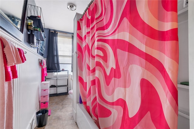 bathroom with tile patterned floors and shower / tub combo with curtain