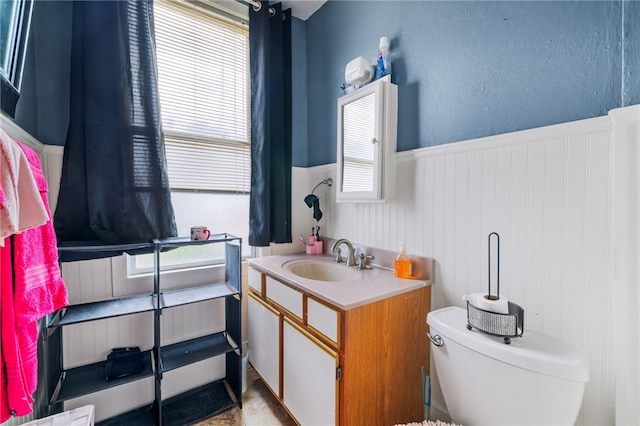 bathroom featuring a wealth of natural light, vanity, tile patterned floors, and toilet