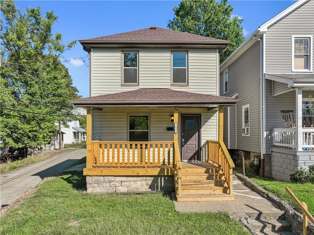 front of property with covered porch and a front yard