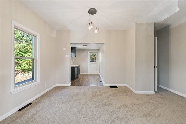 unfurnished living room featuring carpet