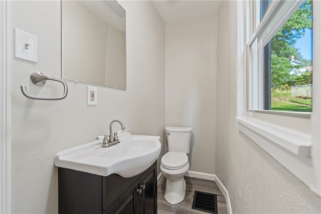 bathroom featuring hardwood / wood-style flooring, vanity, and toilet