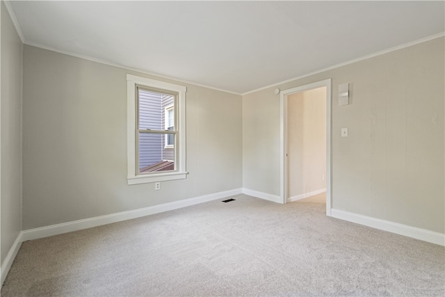 carpeted spare room with ornamental molding