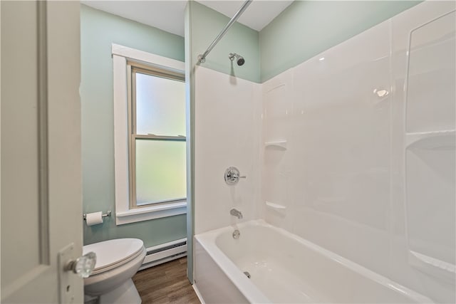 bathroom featuring baseboard heating, washtub / shower combination, toilet, and wood-type flooring