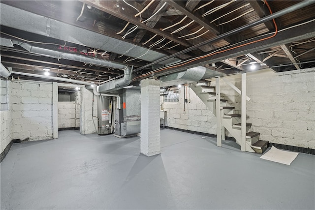 basement featuring gas water heater and heating unit