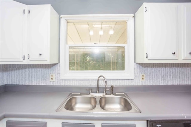 kitchen featuring sink, decorative backsplash, and white cabinets