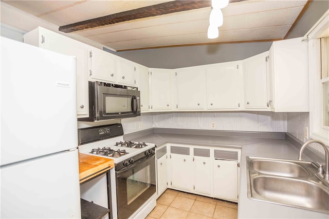 kitchen featuring light tile patterned flooring, white appliances, white cabinets, beamed ceiling, and sink