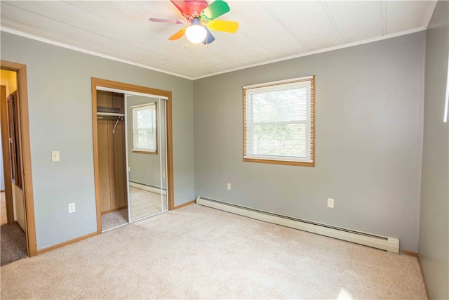 unfurnished bedroom with ceiling fan, a baseboard heating unit, and carpet flooring