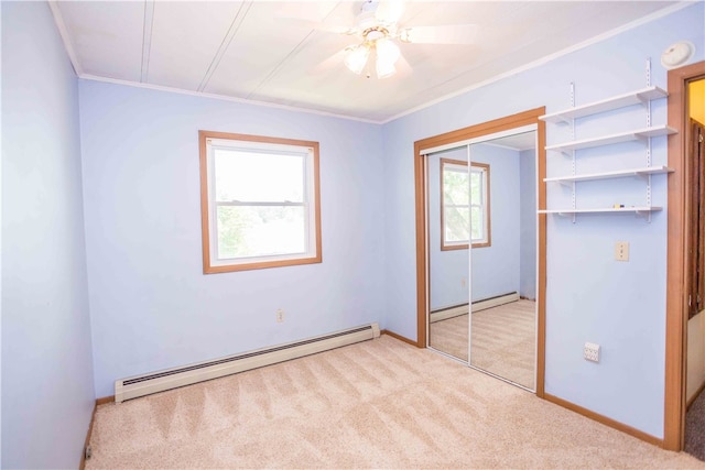 unfurnished bedroom featuring a baseboard radiator, light colored carpet, and ceiling fan