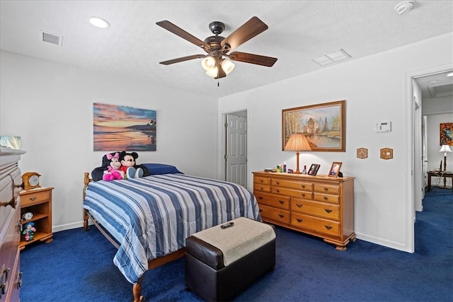 carpeted bedroom featuring ceiling fan and a textured ceiling