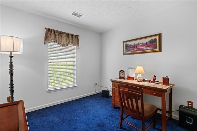 home office featuring dark carpet and a textured ceiling