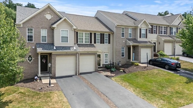 view of front of property featuring a garage and a front lawn