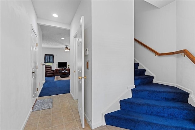 stairway with ceiling fan