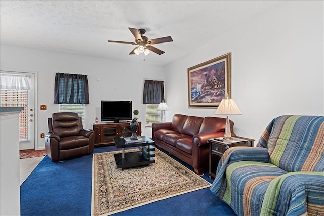 living room with a textured ceiling and ceiling fan