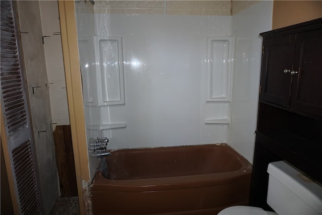 bathroom with toilet and a tub to relax in