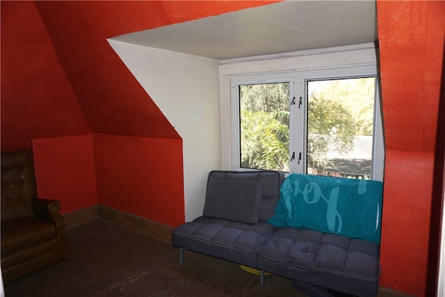 interior space featuring lofted ceiling and dark hardwood / wood-style flooring