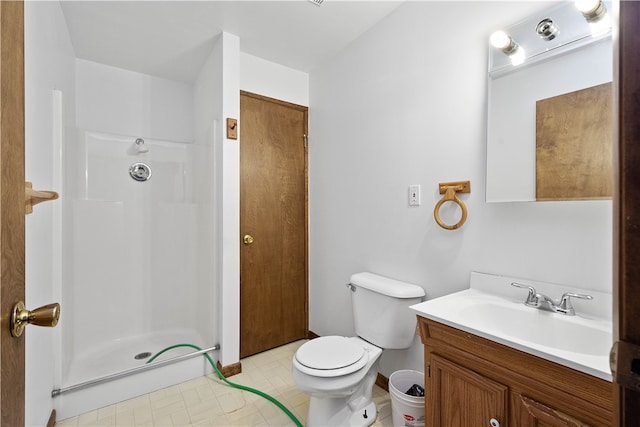 bathroom with walk in shower, tile patterned flooring, toilet, and vanity