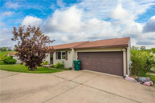 single story home with a garage and a front lawn