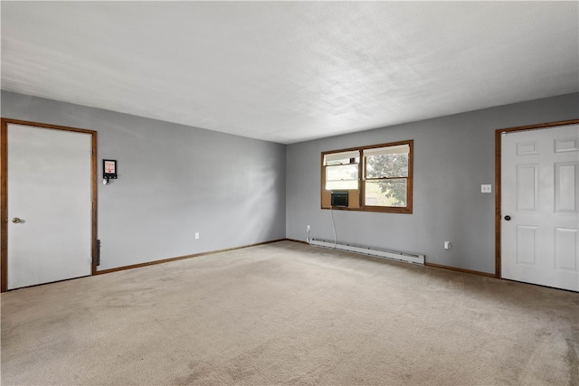 carpeted empty room featuring baseboard heating and cooling unit