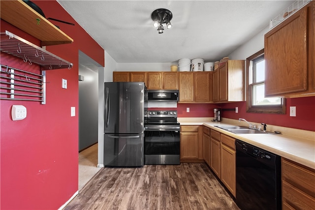 kitchen featuring sink, black appliances, and dark wood-type flooring