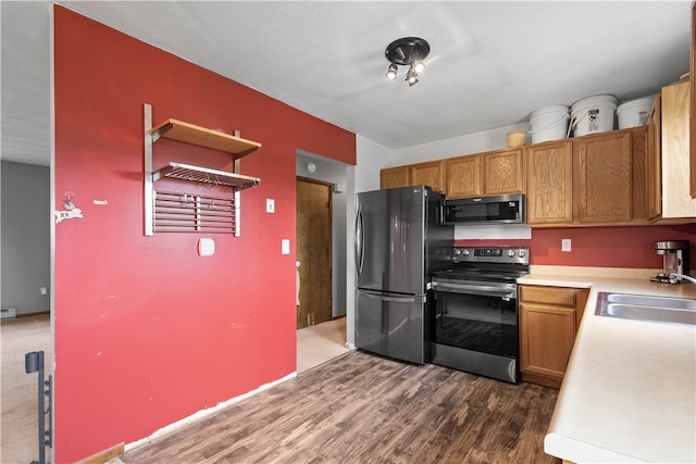 kitchen with carpet, appliances with stainless steel finishes, and sink