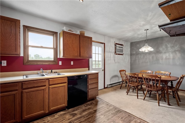 kitchen with dishwasher, sink, hanging light fixtures, an AC wall unit, and dark colored carpet