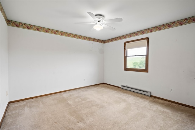 carpeted spare room with ceiling fan and baseboard heating