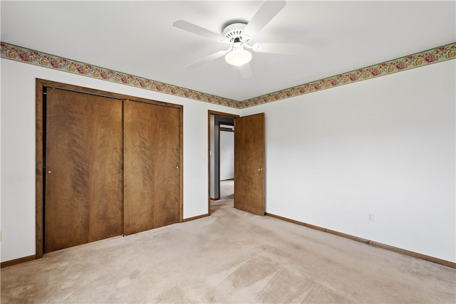 unfurnished bedroom with carpet, ceiling fan, and a closet