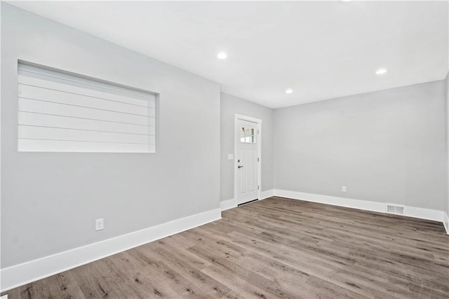 entrance foyer featuring visible vents, recessed lighting, baseboards, and wood finished floors