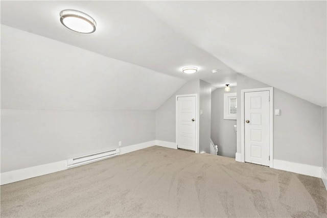 bonus room with vaulted ceiling, carpet flooring, baseboards, and a baseboard radiator