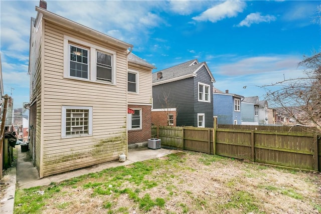 back of house with a patio area, fence, and central AC