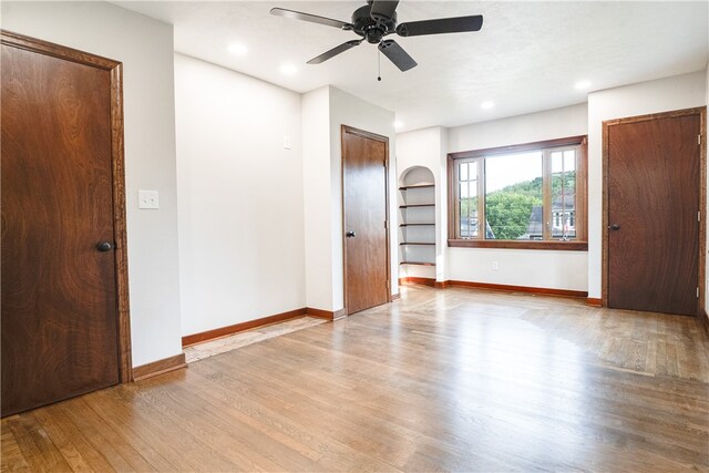 unfurnished room with ceiling fan and light hardwood / wood-style floors